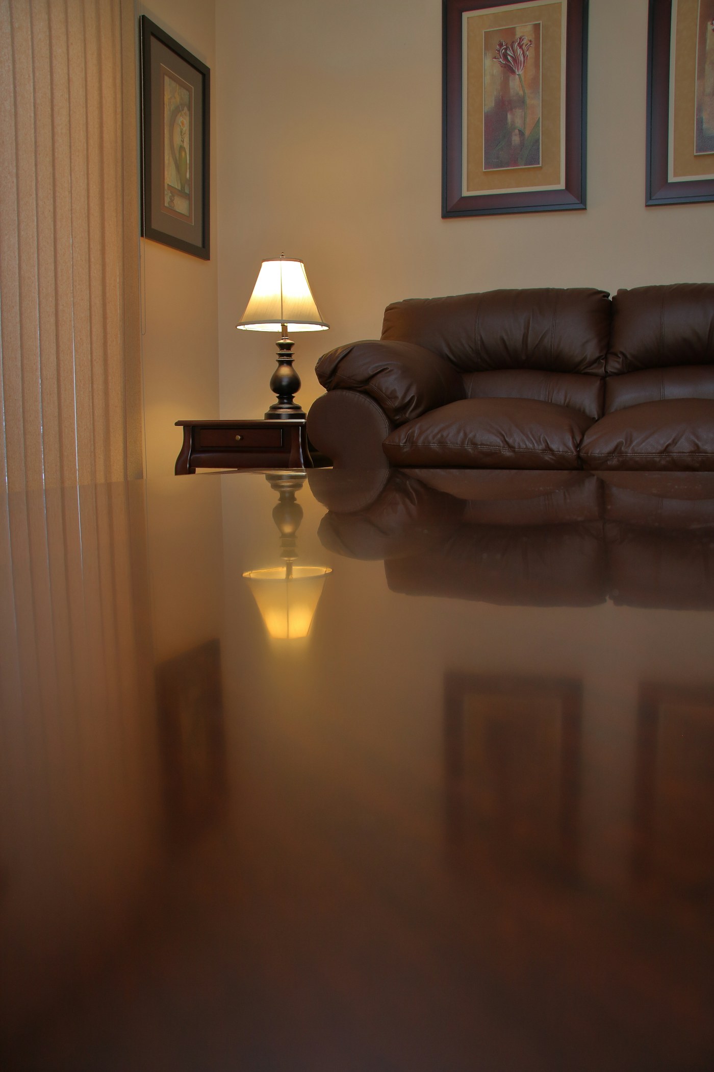 Water flooding a living room floor at night from a plumbing backup