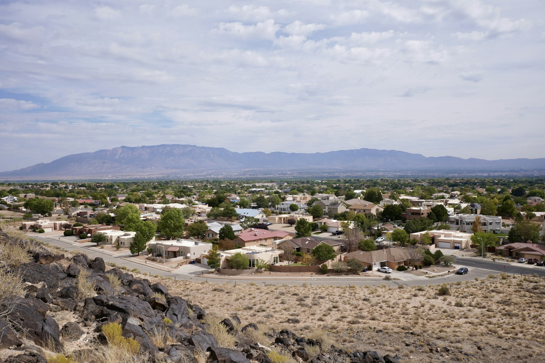 High desert neighborhood homes with the Sandia Mountains in the background